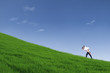 Guy giving piggyback ride on hill under blue sky
