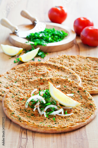 Photo: Traditional Turkish pizza (lahmacun) with meat, selective focus Traditional Turkish pizza (lahmacun) with meat, selective focus