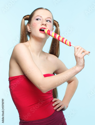Photo: Young singing woman with lollipop Young singing woman with lollipop