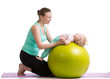 Photo: mother with baby having fun with gymnastic ball mother with baby having fun with gymnastic ball