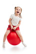 happy child jumping on bouncing ball. Isolated on white