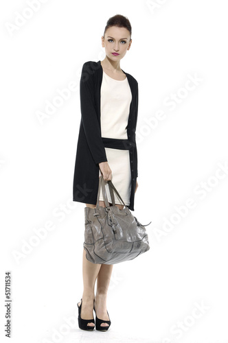 Photo: Full length of fashion model with big bag. Isolated Full length of fashion model with big bag. Isolated