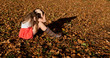 Young girl crying in fallen leaves