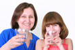 Photo: Smiling woman and girl drink water Smiling woman and girl drink water