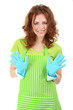 Young woman wearing green apron and rubber gloves, isolated