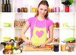 Young woman cooking in kitchen