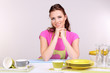 Beautiful young woman wipes clean utensils in kitchen