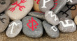 Fortune telling  with symbols on stones on burlap background