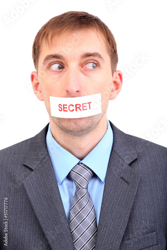 Photo: Young businessman with a band on his mouth isolated on white Young businessman with a band on his mouth isolated on white