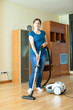   girl cleans with vacuum cleaner