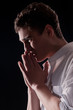 Photo: Low-key portrait of businessman praying for success Low-key portrait of businessman praying for success