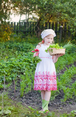 Photo: little girl in garden little girl in garden