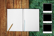 Photo: Notebook with photo frames on wooden floor and grass field Notebook with photo frames on wooden floor and grass field