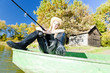 Foto: fishing woman sitting on boat fishing woman sitting on boat
