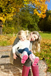mother with her little daughter in autumnal nature