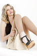 sitting woman wearing summer clothes and shoes with a handbag