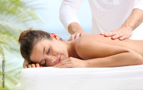 Photo: Brunette girl receiving a massage Brunette girl receiving a massage