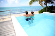 Couple looking at the sea from swimming-pool