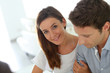 Woman with husband siging purchasing contract