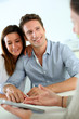 Photo: Young couple meeting financial adviser Young couple meeting financial adviser