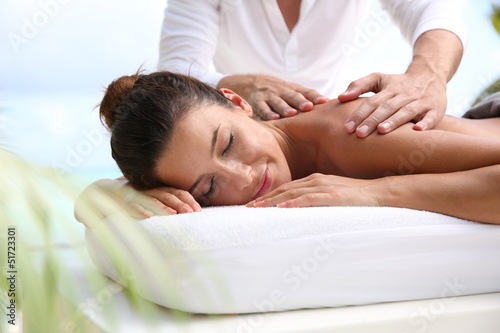 Photo: Brunette girl receiving a massage Brunette girl receiving a massage