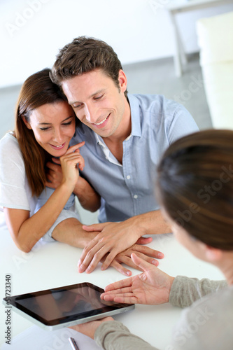 Photo: Young couple meeting financial adviser Young couple meeting financial adviser