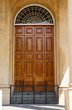 Old Carved Wood Door in Stucco Building