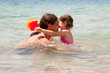 Father and baby daughter playing in the water.