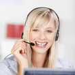 freundliche mitarbeiterin telefoniert mit headset
