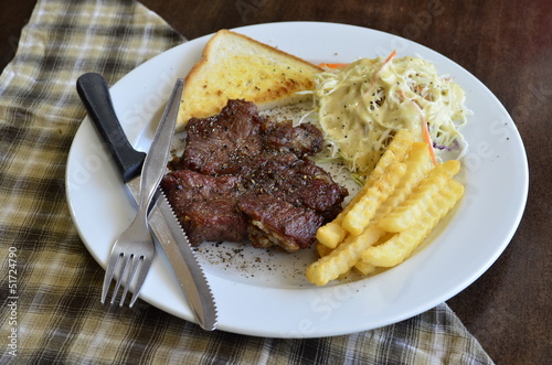 Photo: Grilled steak, French fries and vegetables Grilled steak, French fries and vegetables