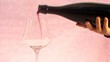 red wine glass over pink background