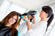 Foto: Stylist blow drying hair Stylist blow drying hair