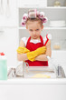 Grumpy little girl washing dishes
