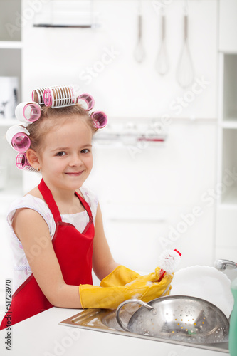 Photo: Little girl with big curls doing the dishes Little girl with big curls doing the dishes