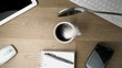 Spoon being spilled into and around a cup of coffee