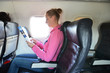Foto: Girl reading a magazine in the airplane Girl reading a magazine in the airplane
