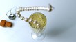String of pearls dropping in glass of champagne