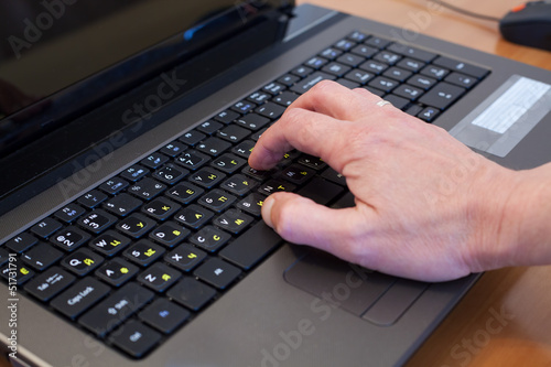 Photo: man's hand on a computer keyboard man's hand on a computer keyboard
