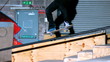 Skater doing crook slide down rail