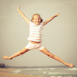 flying jump beach girl on blue sea shore in summer vacation