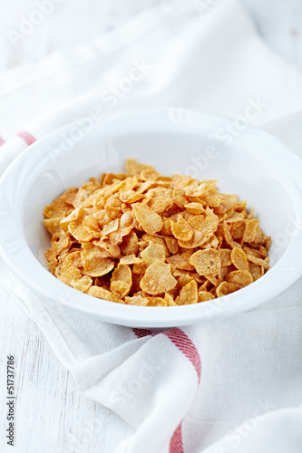 Photo: Corn flakes in a white bowl Corn flakes in a white bowl