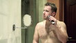 Video: Young man shaving in front of mirror Young man shaving in front of mirror