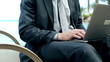 Closeup of businessman typing on laptop computer, steadycam shot