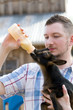 Man Bottle Feeds Goat