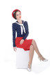 Foto: Beautiful pin up model siting isolated Beautiful pin up model siting isolated