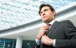 Businessman adjusting his tie