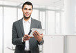 Business man holding his digital tablet