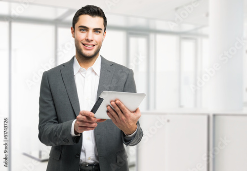 Photo: Business man holding his digital tablet Business man holding his digital tablet