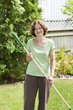 Photo: Senior woman holding rake Senior woman holding rake