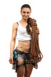 Young female rock climber wearing safety harness and with rope